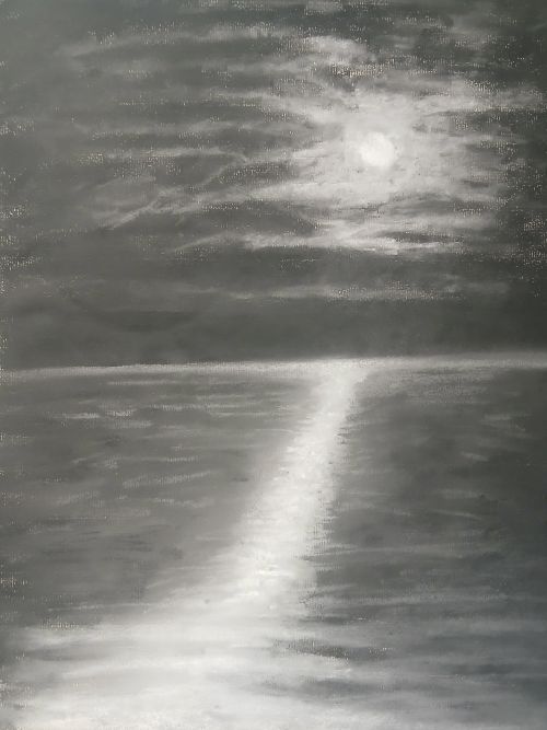 Moon peeking throgh clouds on a dark night